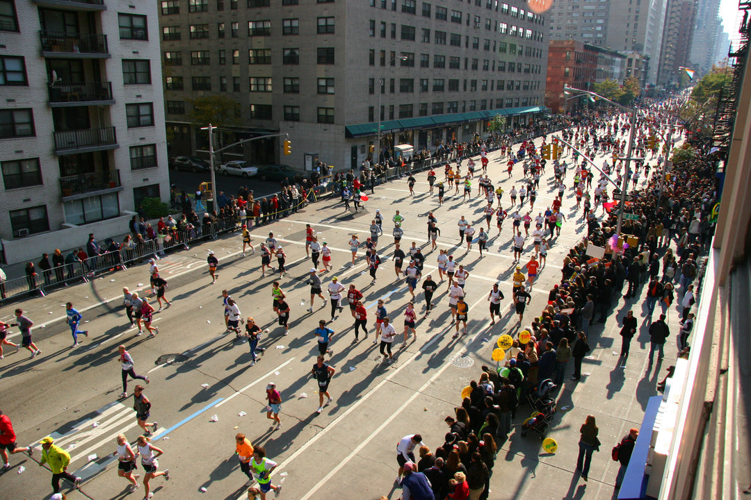 Hundreds of people participating in a marathon through a city street